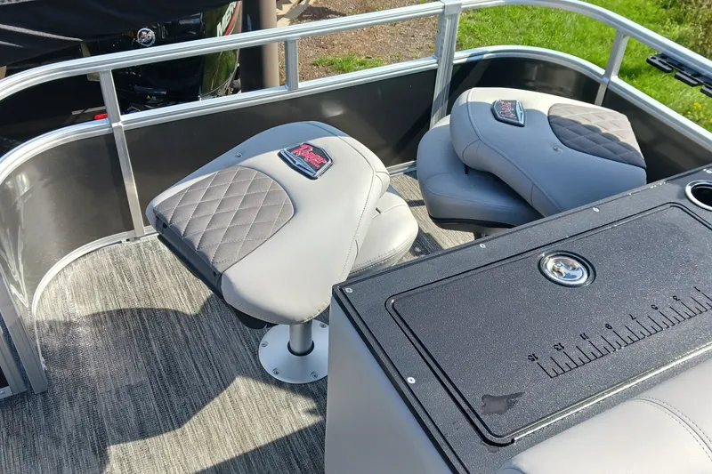 Slide: The Image of 2025 Ranger Reata 220FC boat interior with cushioned seats and fishing station. - 6