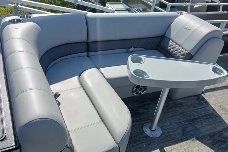 Slide: The Image of 2025 Ranger Reata 220FC boat interior with gray seating and table. - 7