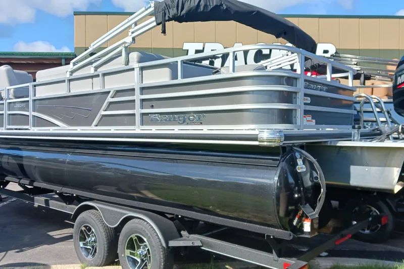 The Image of 2025 Ranger Reata 220FC pontoon boat on trailer, displayed outdoors. - 0