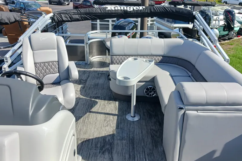 Slide: The Image of 2025 Ranger Reata 220FC pontoon boat interior with plush seating and modern helm. - 4