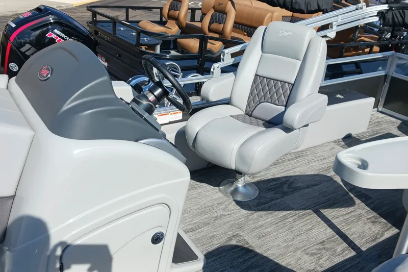 Slide: The Image of 2025 Ranger Reata 220FC boat interior with luxurious seating and modern steering console. - 11