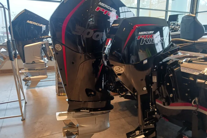 Slide: The Image of 2025 Nitro ZV20 boat with Mercury Pro Kicker outboard motors displayed indoors. - 11