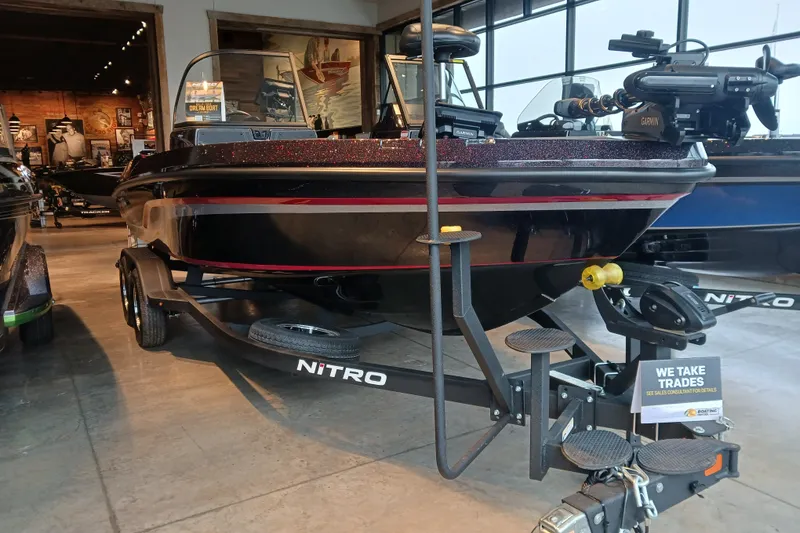 Slide: The Image of 2025 Nitro ZV20 boat on display in showroom, featuring sleek black design. - 1