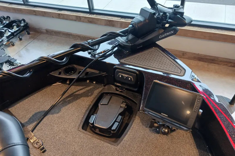 Slide: The Image of 2025 Nitro ZV20 boat dashboard with Garmin navigation system and foot pedal controls. - 2