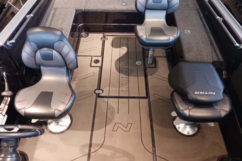Slide: The Image of Interior of 2025 Nitro ZV20 boat with three cushioned seats and measuring ruler. - 6
