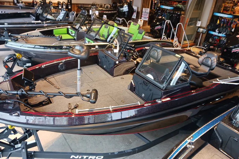 The Image of 2025 Nitro ZV20 fishing boat displayed in showroom with modern seating and equipment. - 0