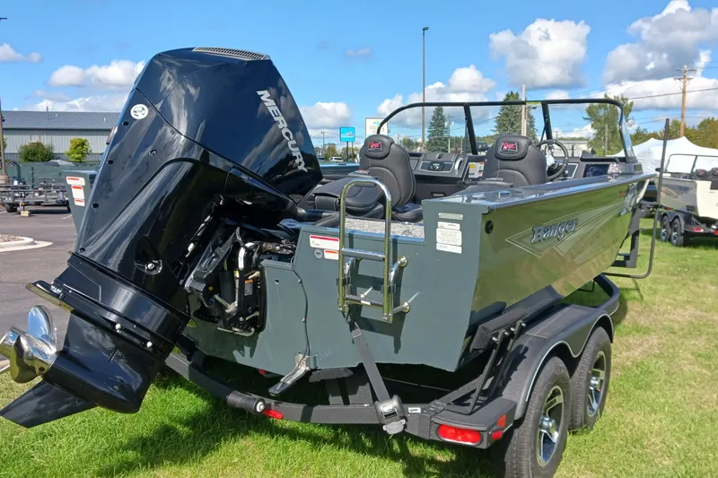 Slide: The Image of 2025 Ranger VX1888 WT boat with Mercury engine on a trailer, parked outdoors. - 2