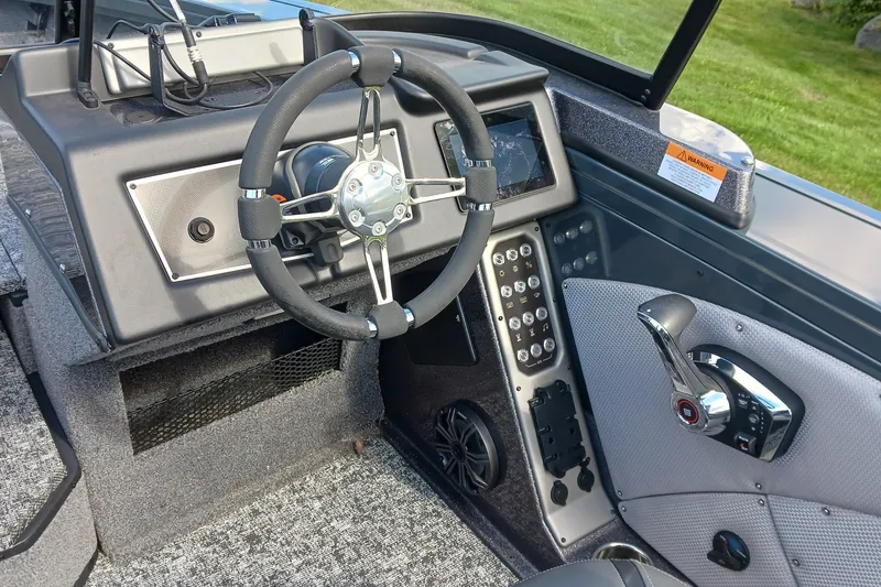 Slide: The Image of 2025 Ranger VX1888 WT boat cockpit with steering wheel and control panel. - 7