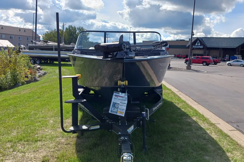 Slide: The Image of 2025 Ranger VX1888 WT boat on trailer, parked outdoors under cloudy sky. - 1