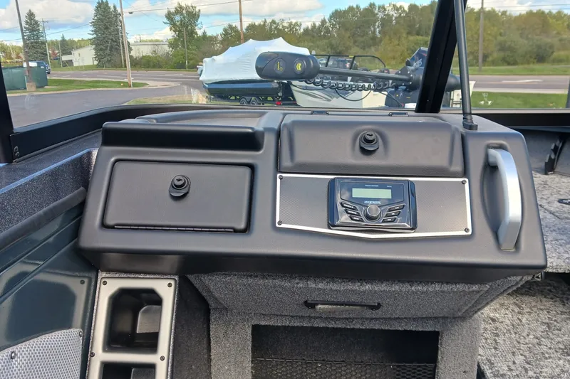 Slide: The Image of 2025 Ranger VX1888 WT boat dashboard with control panel and storage compartments. - 6