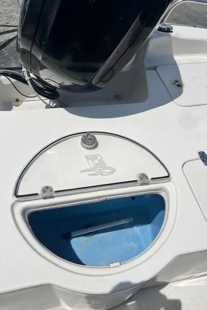 Slide: The Image of 2016 Carolina Skiff 218 DLV boat deck with storage compartment and motor. - 13