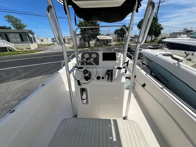Slide: The Image of 2016 Carolina Skiff 218 DLV boat interior with steering console and controls. - 3