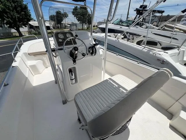Slide: The Image of 2016 Carolina Skiff 218 DLV boat interior with steering console and seating. - 4