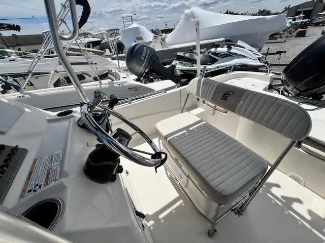 Slide: The Image of 2016 Carolina Skiff 218 DLV boat interior with steering wheel and seating. - 5