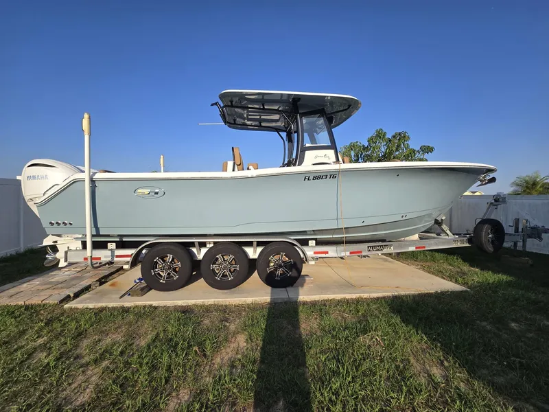 Slide: The Image of 2022 Sea Hunt Gamefish 30 boat on trailer, side view, clear sky background. - 1