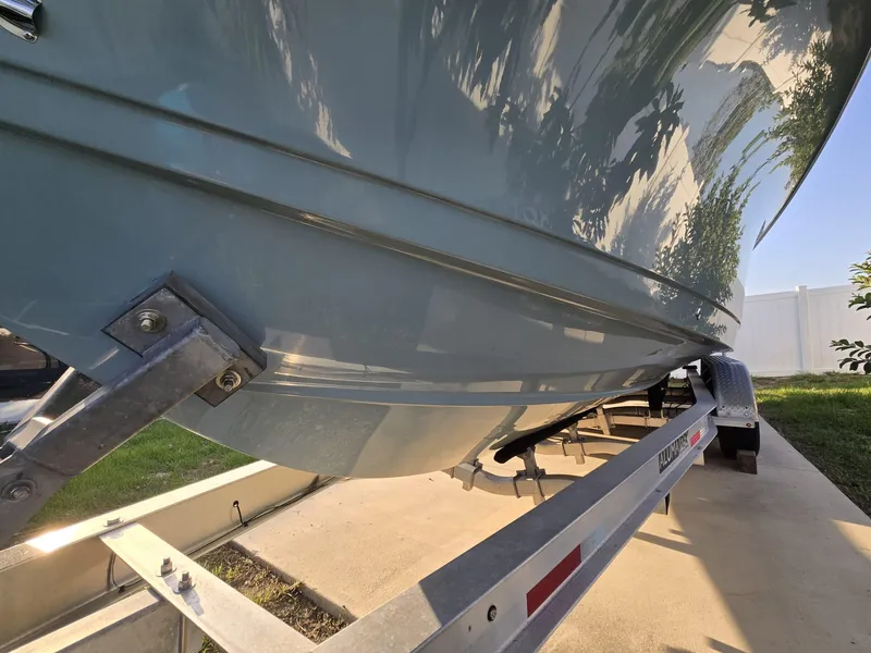 Slide: The Image of 2022 Sea Hunt Gamefish 30 boat on trailer, close-up view of hull and trailer. - 15