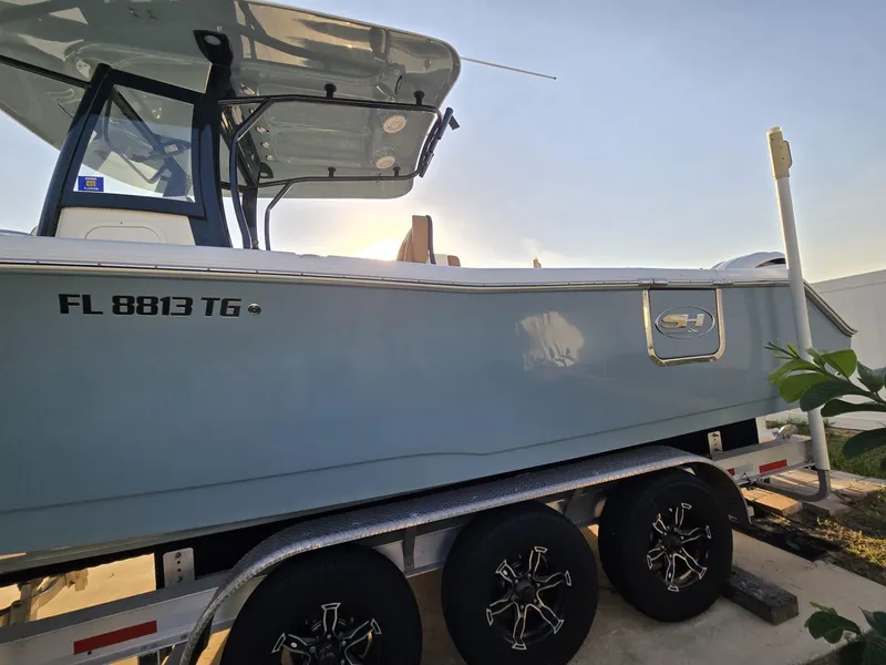 Slide: The Image of 2022 Sea Hunt Gamefish 30 on trailer, side view, with forward seating, in sunlight. - 18