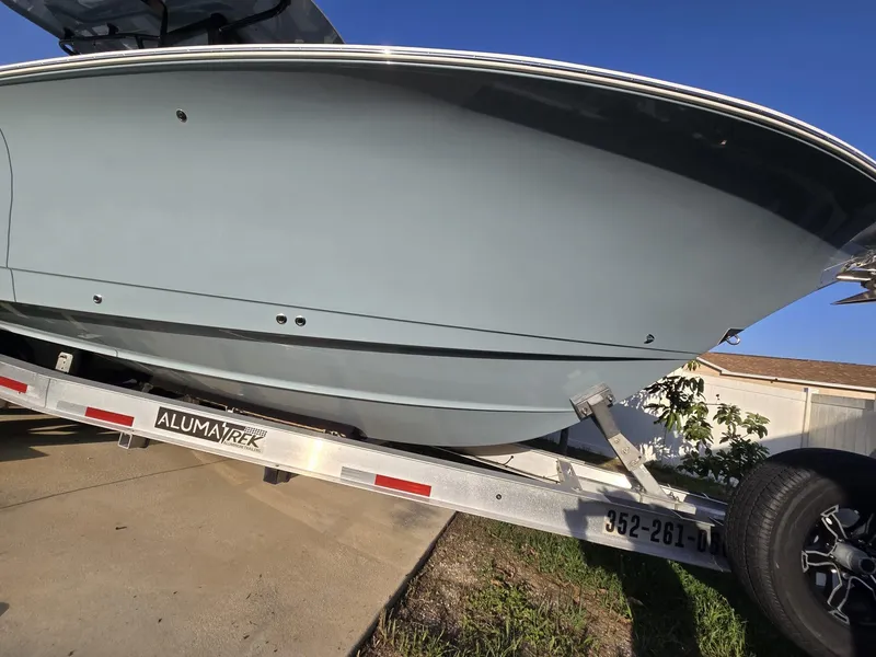 Slide: The Image of 2022 Sea Hunt Gamefish 30 on trailer, side view, blue hull, Alumatech trailer. - 20