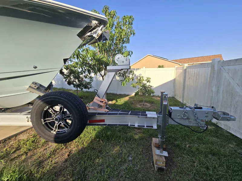 Slide: The Image of 2022 Sea Hunt Gamefish 30 on trailer, parked in a grassy yard. - 33