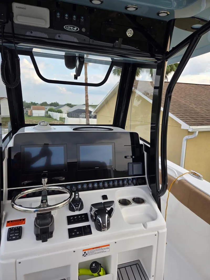 Slide: The Image of 2022 Sea Hunt Gamefish 30 helm with dual displays and modern controls. - 39