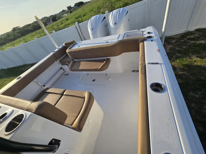 Slide: The Image of 2022 Sea Hunt Gamefish 30 boat with forward seating, dual engines, and spacious deck. - 4