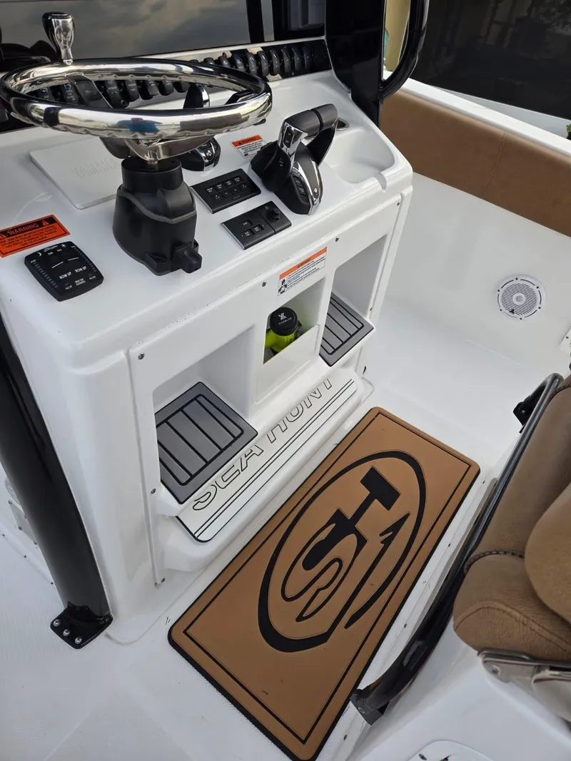 Slide: The Image of 2022 Sea Hunt Gamefish 30 helm with controls and seating area. - 41