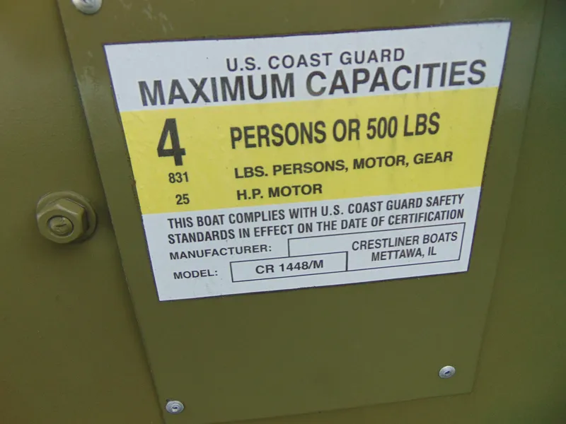 Slide: The Image of 2024 Crestliner 1448M CR Jon boat capacity label, 4 persons or 500 lbs, U.S. Coast Guard compliant. - 6