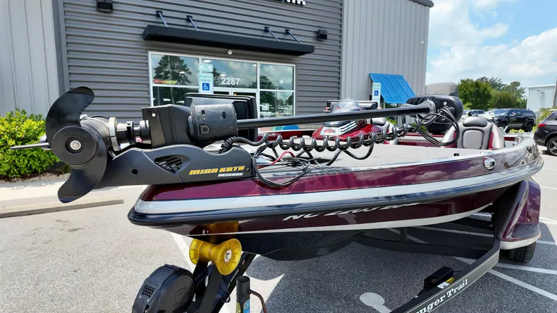Slide: The Image of 2018 Ranger Z 518c boat with trolling motor, parked outside a building. - 12