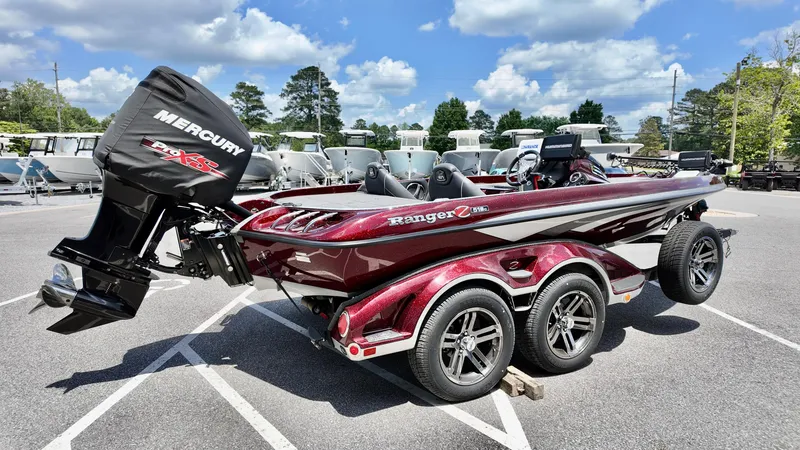 Slide: The Image of 2018 Ranger Z 518c boat with Mercury engine, parked outdoors on a sunny day. - 15