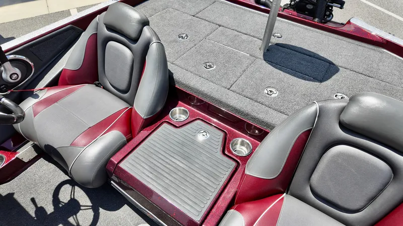 Slide: The Image of 2018 Ranger Z 518c boat interior with red and gray seats, cup holders, and storage compartments. - 6