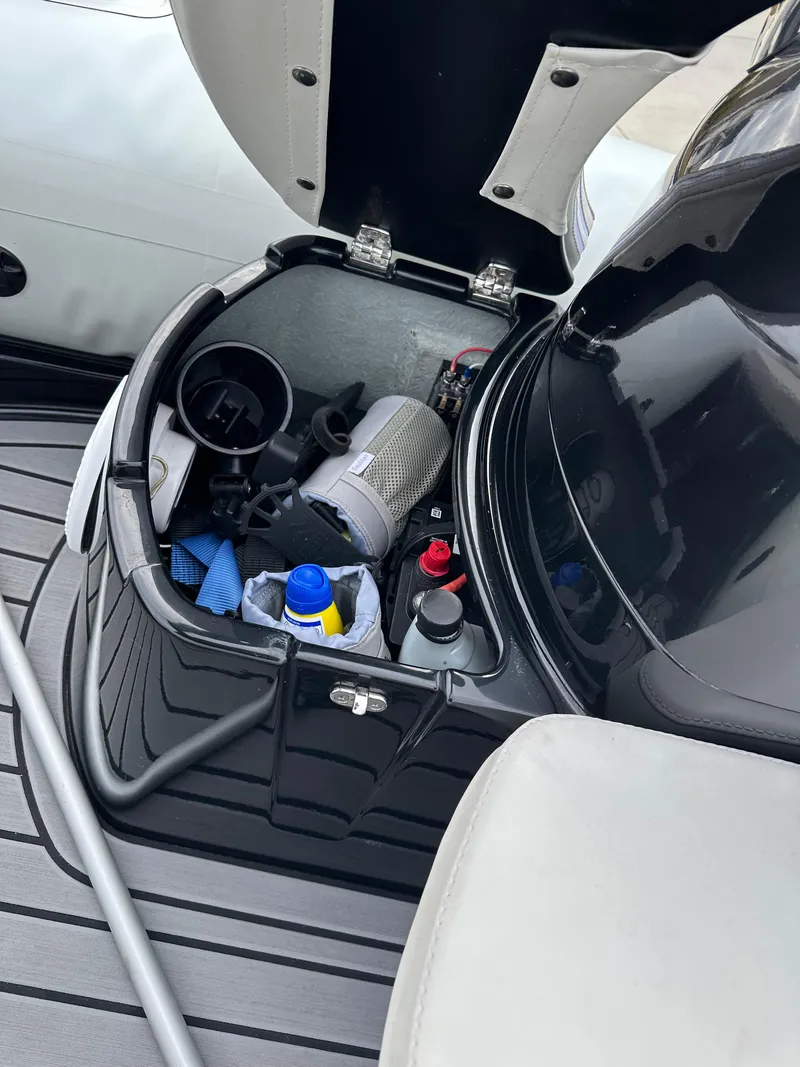 Slide: The Image of Storage compartment of 2022 Grand Inflatables G380 boat with various items inside. - 14
