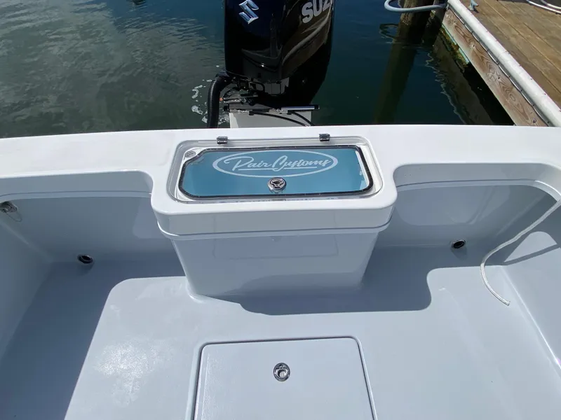 Slide: The Image of 2023 Pair Customs 21 Center Console DV boat, featuring a sleek deck and Suzuki outboard motor. - 11