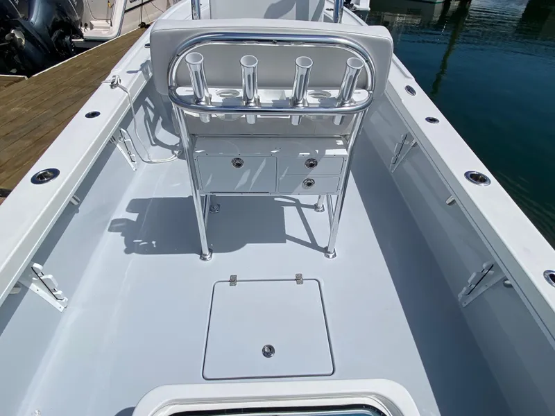 Slide: The Image of 2023 Pair Customs 21 Center Console DV boat interior with rod holders and storage. - 14