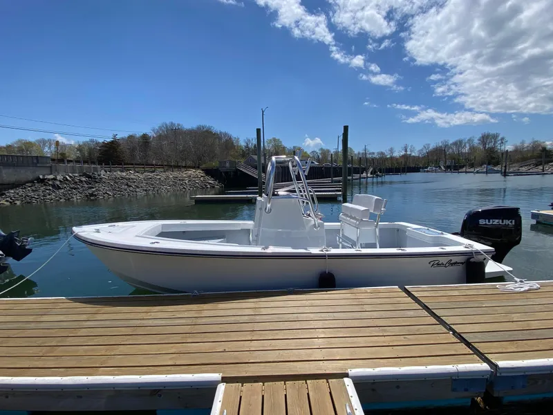 Slide: The Image of 2023 Pair Customs 21 Center Console DV boat docked on a sunny day. - 3