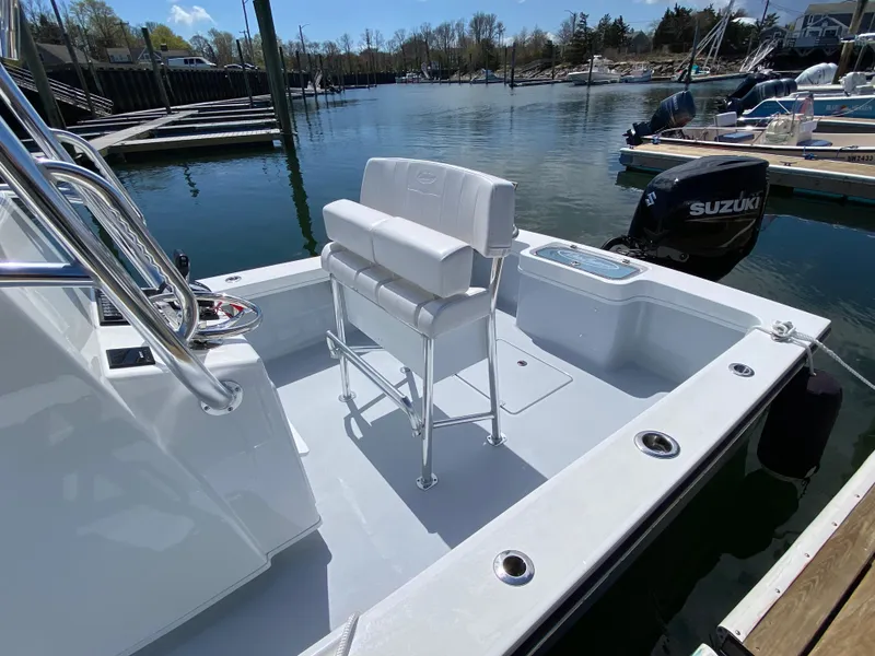 Slide: The Image of 2023 Pair Customs 21 Center Console DV boat with Suzuki outboard, docked in a marina. - 6