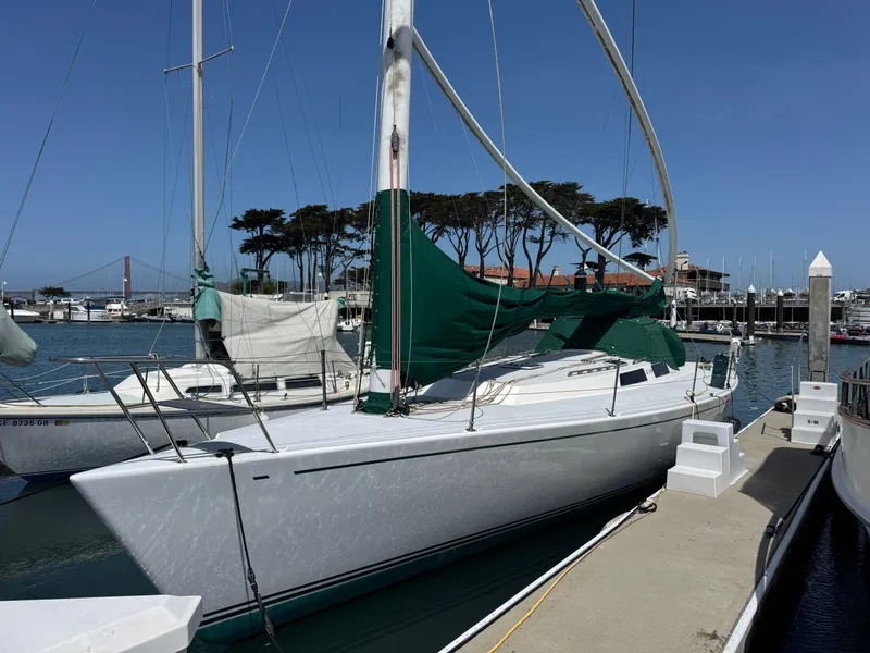 Slide: The Image of Sailboat Wyliecat 48, 2000 model, docked in a marina with clear blue skies. - 3