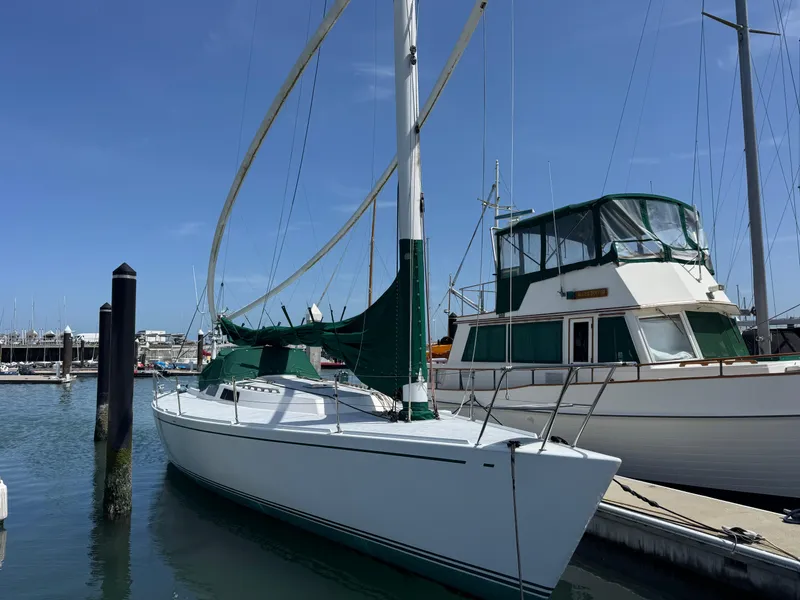 Slide: The Image of Sailboat docked in marina, Wyliecat 48, year 2000, with green sail cover. - 4
