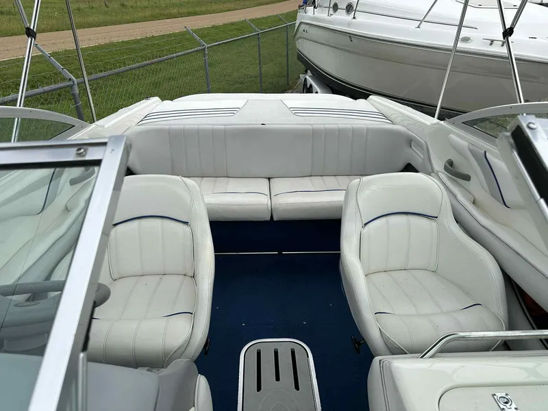 Slide: The Image of 1994 Sea Ray 220 Bow Rider interior with white seating and blue carpet. - 11
