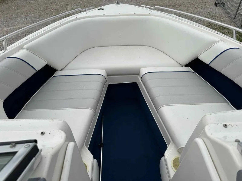 Slide: The Image of 1994 Sea Ray 220 Bow Rider interior with white cushioned seating. - 12