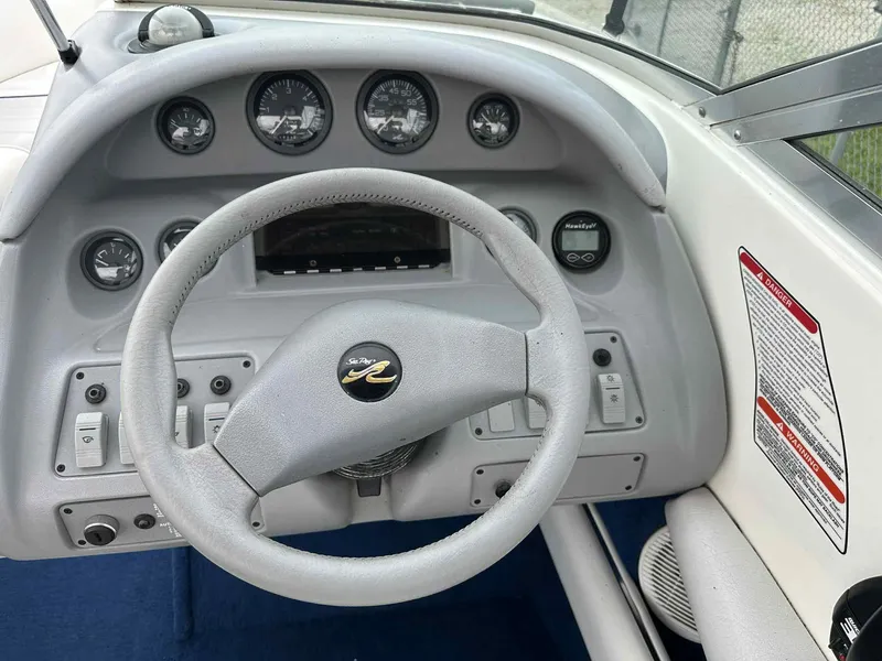 Slide: The Image of 1994 Sea Ray 220 Bow Rider dashboard with steering wheel and instrument panel. - 14