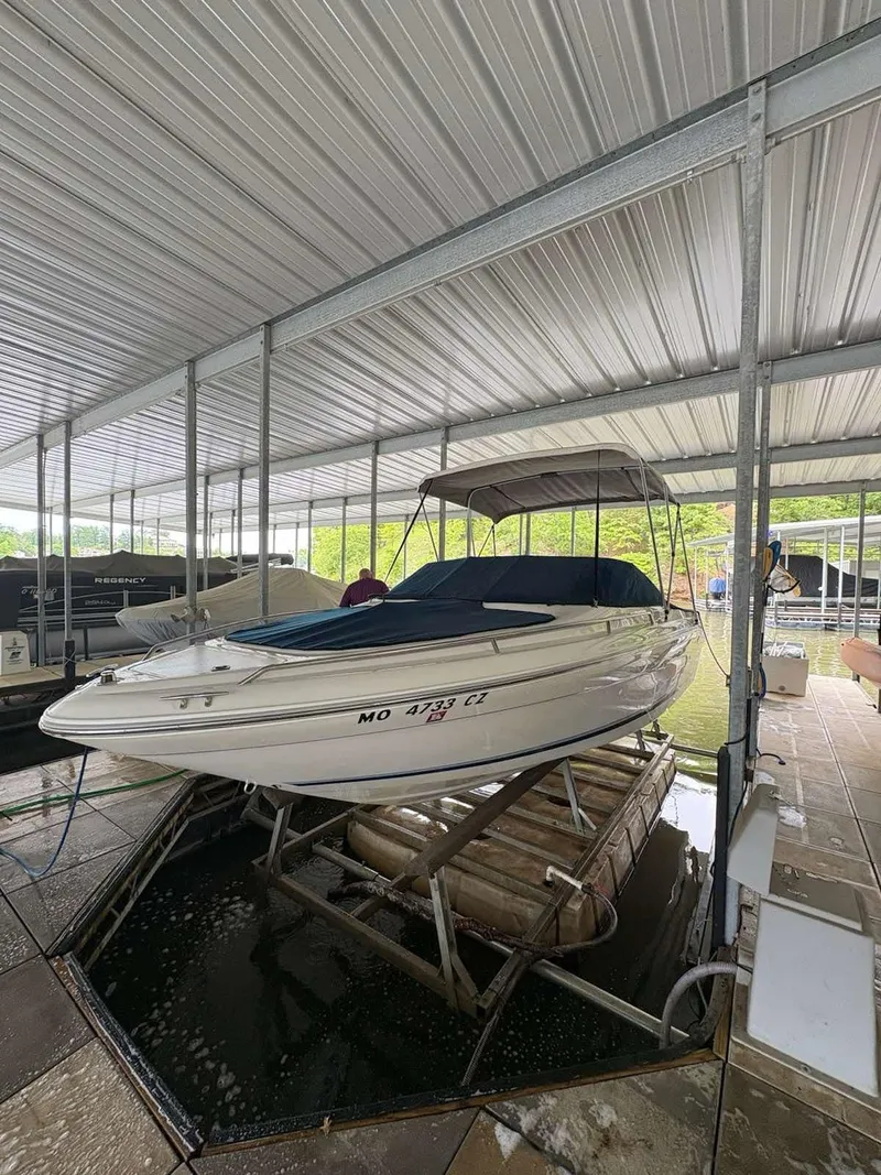 Slide: The Image of 1994 Sea Ray 220 Bow Rider boat docked in covered marina. - 15
