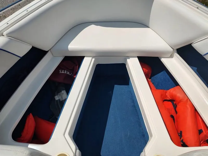 Slide: The Image of Interior of a 1994 Sea Ray 220 Bow Rider with life jackets and storage compartments. - 19