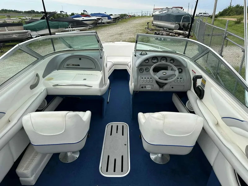 Slide: The Image of 1994 Sea Ray 220 Bow Rider interior with white seating and blue carpet. - 21