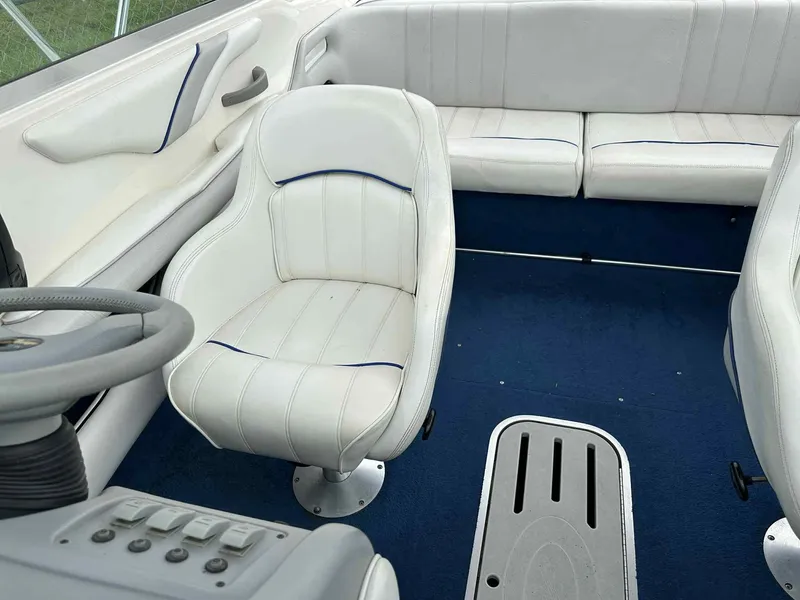 Slide: The Image of Interior of a 1994 Sea Ray 220 Bow Rider with white seating and blue carpet. - 23