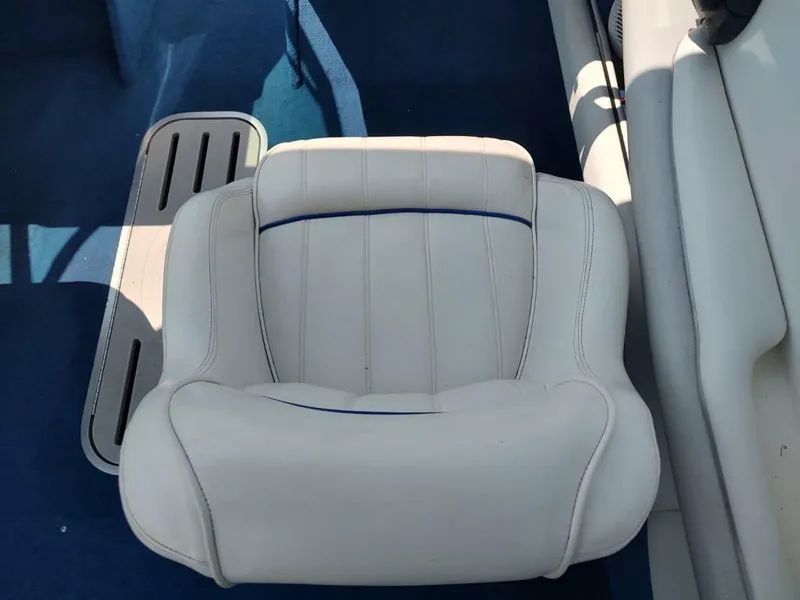 Slide: The Image of White seat on a 1994 Sea Ray 220 Bow Rider boat with blue carpet. - 25