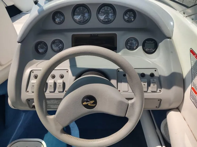 Slide: The Image of Dashboard of a 1994 Sea Ray 220 Bow Rider boat with steering wheel and gauges. - 30