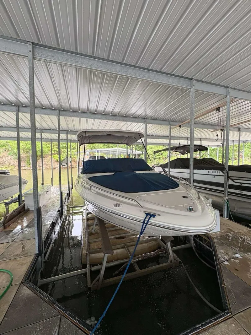 Slide: The Image of 1994 Sea Ray 220 Bow Rider boat docked under a covered marina. - 4
