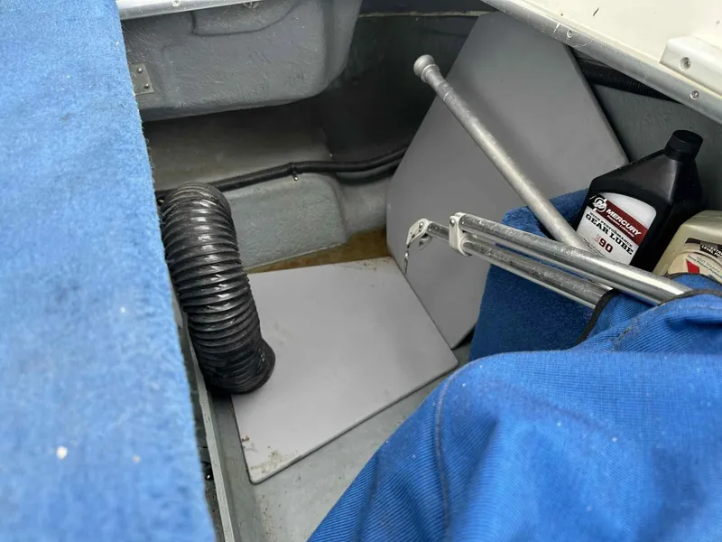 Slide: The Image of Interior of a 1994 Sea Ray 220 Bow Rider with maintenance supplies and equipment. - 8