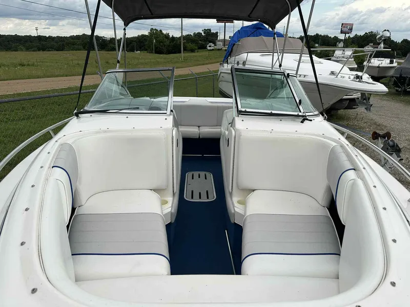 Slide: The Image of 1994 Sea Ray 220 Bow Rider with white seating and open bow area. - 9