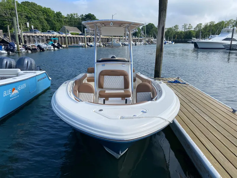 Slide: The Image of 2023 Pioneer 202 Sportfish boat docked at marina, featuring sleek design and comfortable seating. - 1